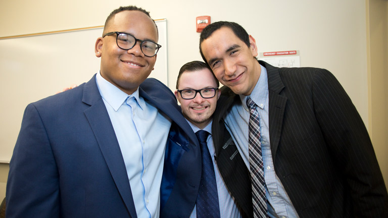 Three students smiling