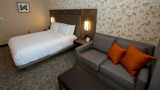 Bed and couch in room Inn at Water's Edge