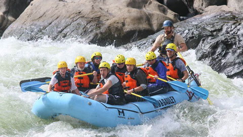 nine COD students kayak in a white water raft