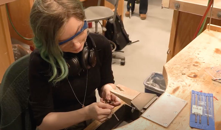 a student welding in the metalworking lab